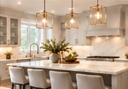 A bright kitchen with brass pendant lights and an island.