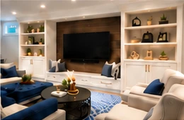A basement living area with a media wall and built-in shelving.